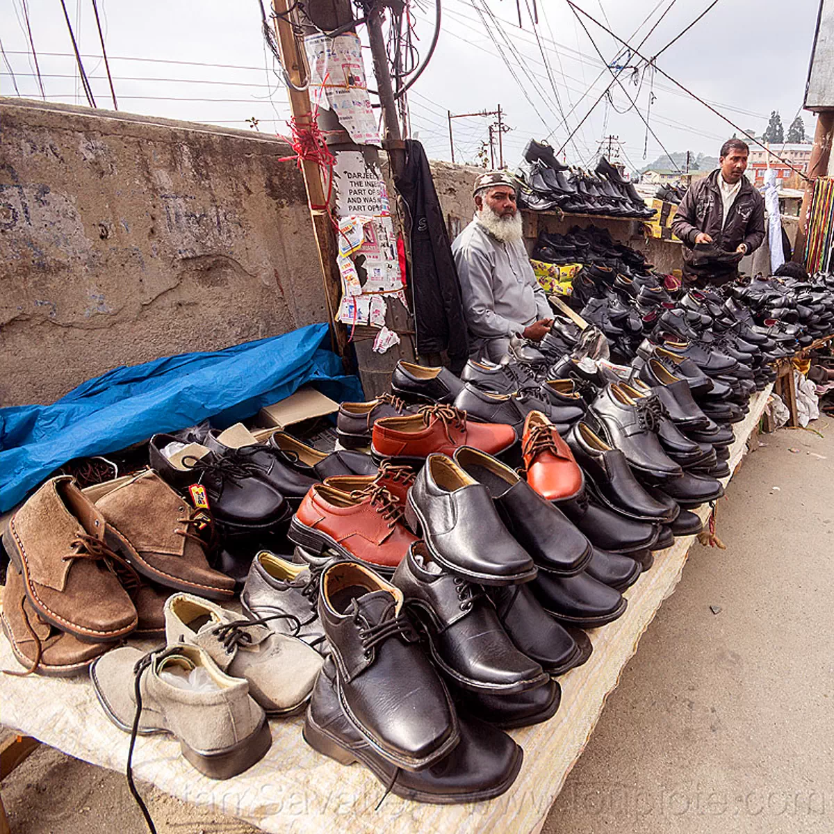 shoe seller in street market, india