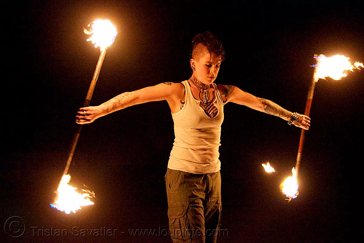 spinning fire staffs (san francisco) - fire dancer - leah, double staff, fire dancer, fire dancing, fire performer, fire spinning, fire staffs, fire staves, leah, night, spinning fire, tattooed, tattoos, woman