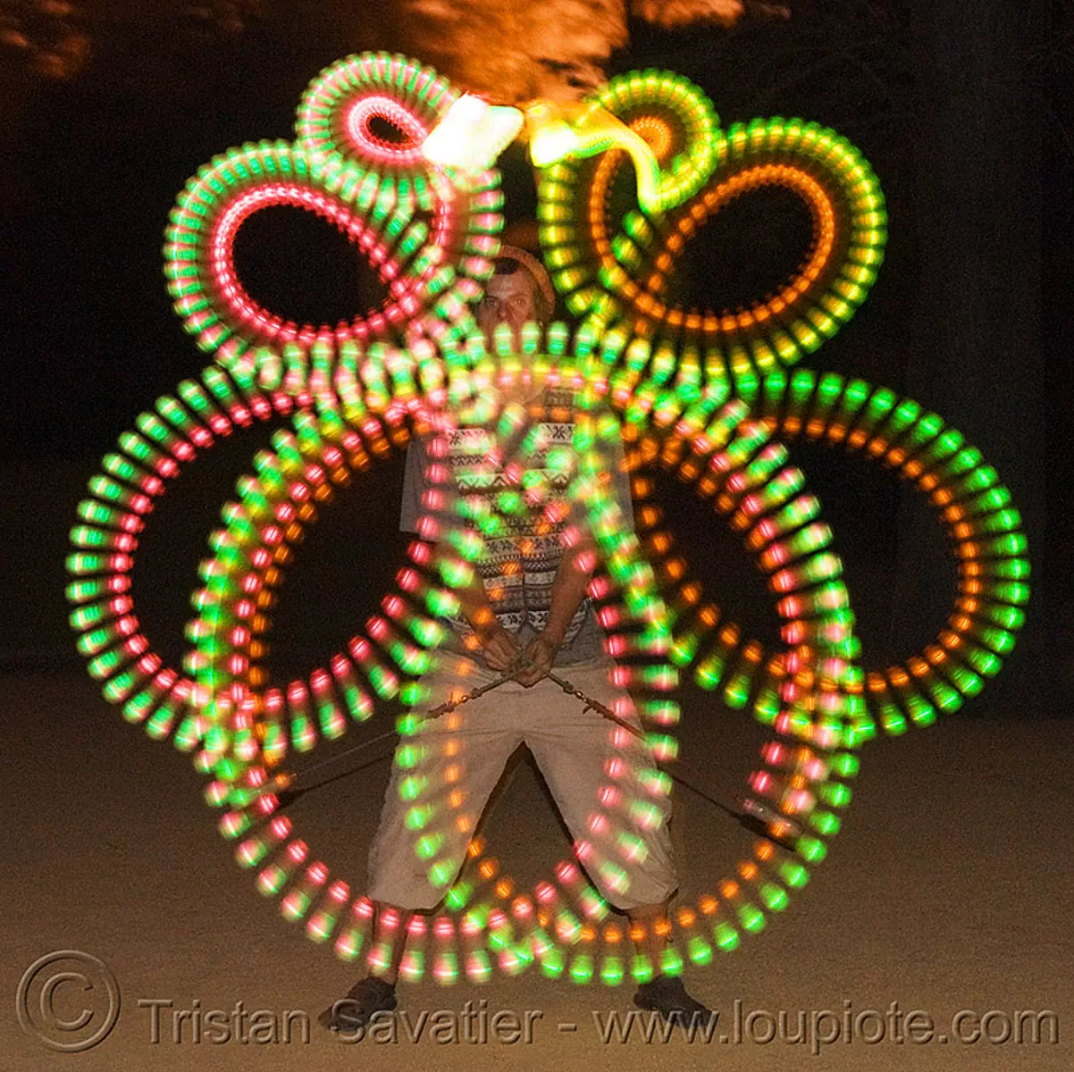 spinning LED light poi - glowing - flowlight, fire dancer, fire dancing, fire performer, fire spinning, glowing, led lights, led poi, led staff, light poi, loops, man, nicky evers, night, spinning fire, vertical symmetry