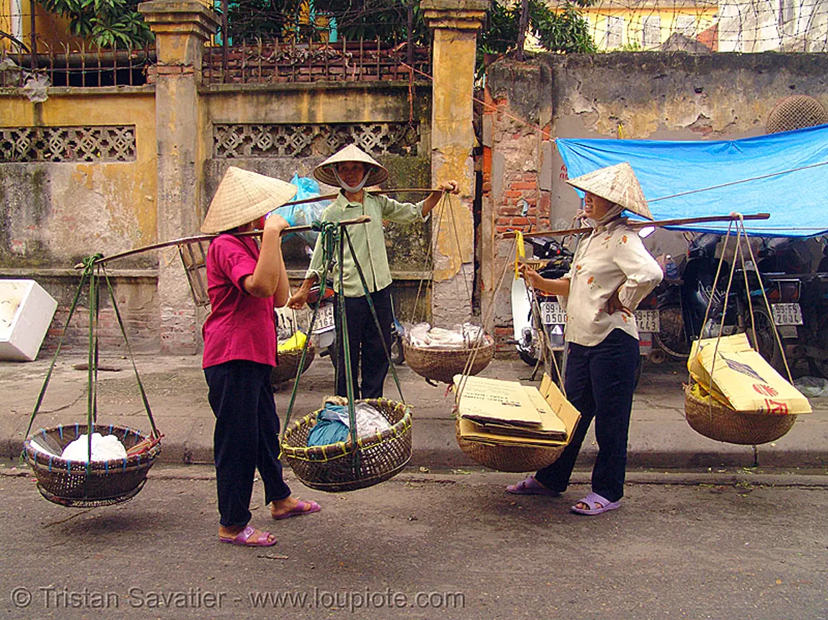 street vendors carrying twin baskets suspended from shoulder poles - vietnam, hanoi, shoulder pole, street market, street seller, twin baskets, vietnam