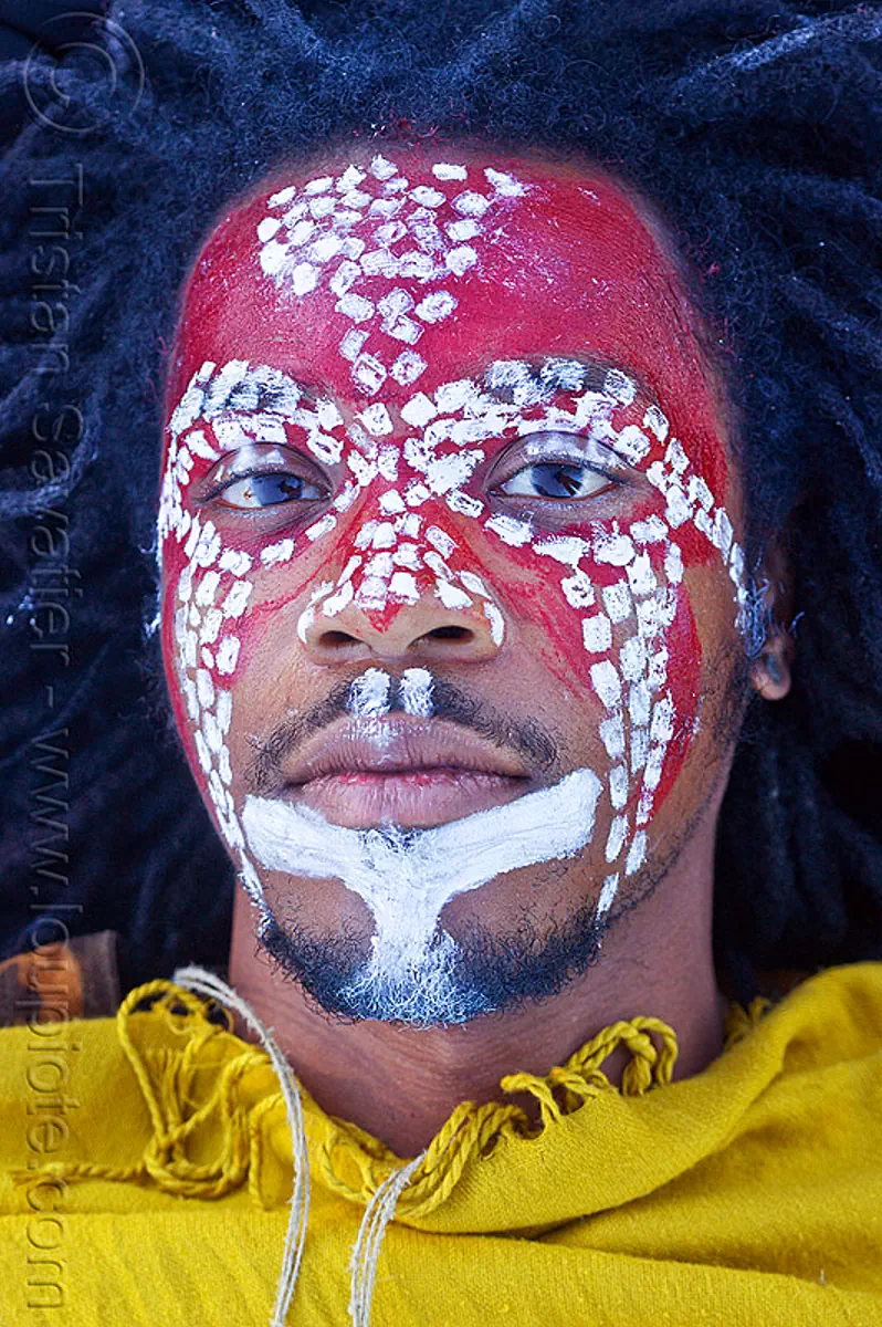 tribal face paint, african american man, african face paint, black man, dreadlocks, face painting, facepaint, indigenous culture, jason, lying down, makeup, red, tribal face paint, white dots, yellow tunic
