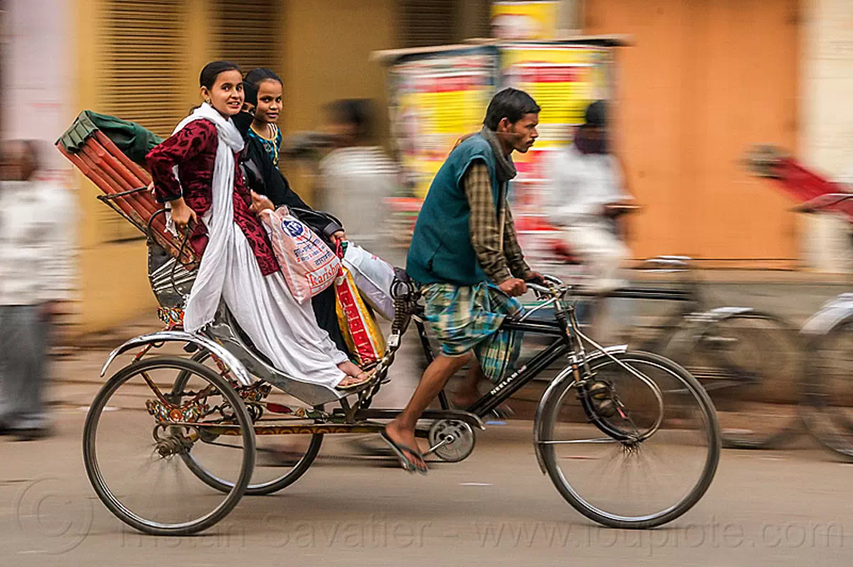 two young women on cycle rickshaw (india), bags, cycle rickshaw, india, man, moving, varanasi, women