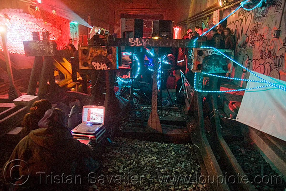 underground rave party in abandoned train tunnel, buffer stop ...