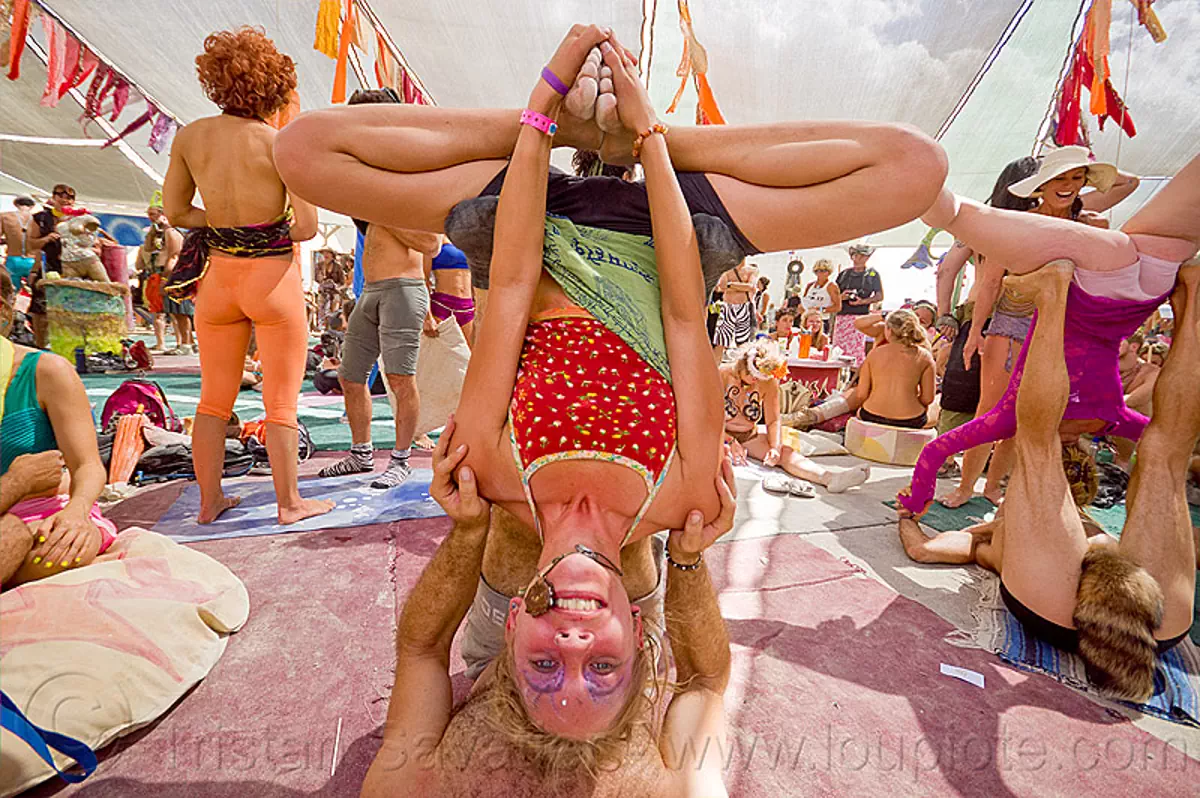 upside-down lotus - acroyoga - burning man 2012, acro-yoga, burning man, crowd, upside-down, woman