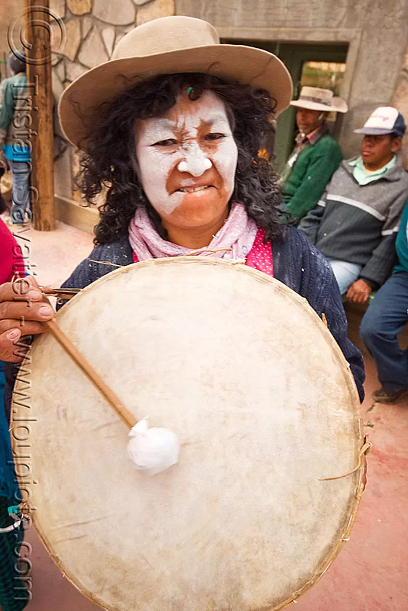 woman playing traditional andean caja drum