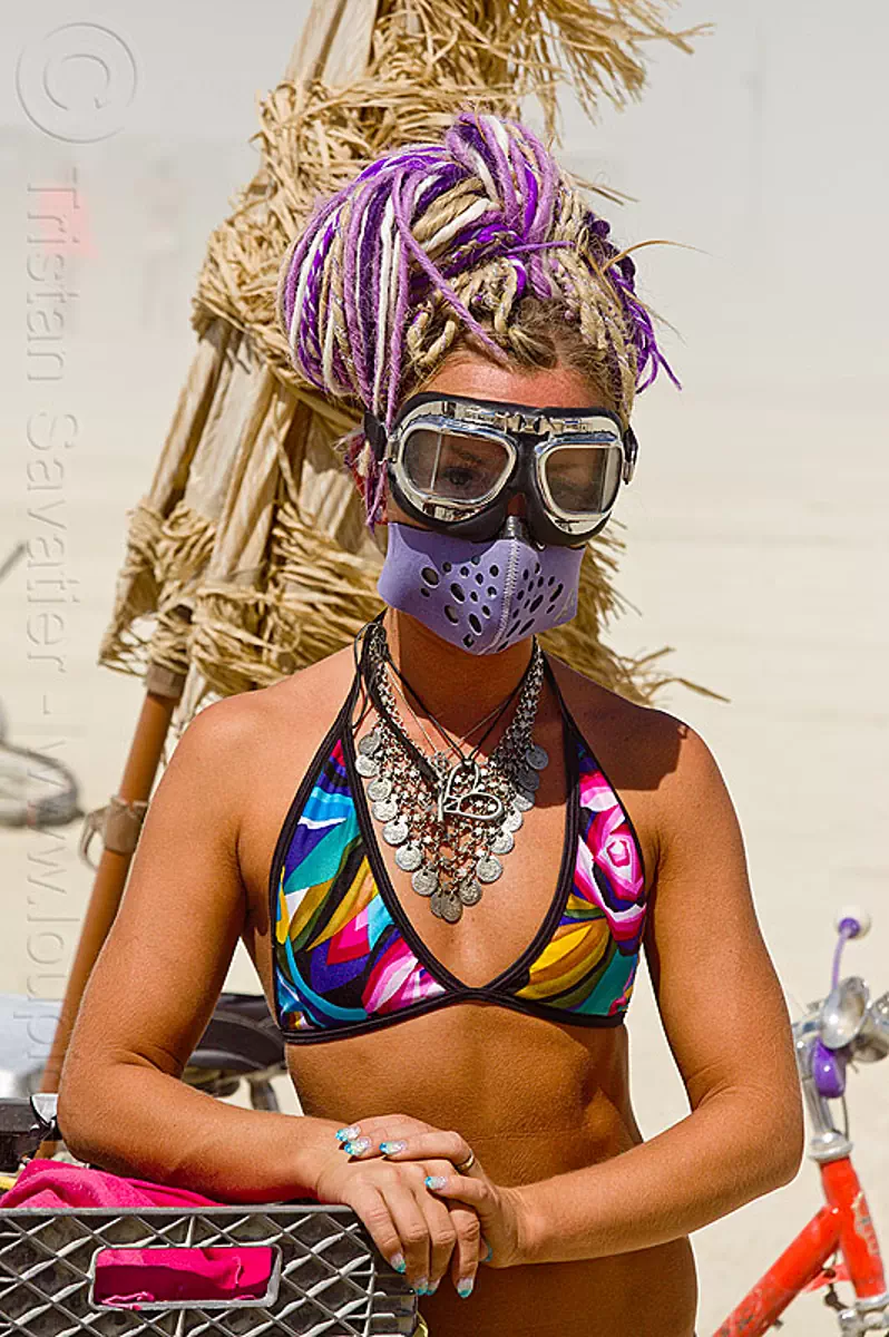 woman with motorcycle goggles and dust mask - burning man 2013, burning man, dust mask, metal necklace, motorcycle goggles, purple dreadlocks, woman