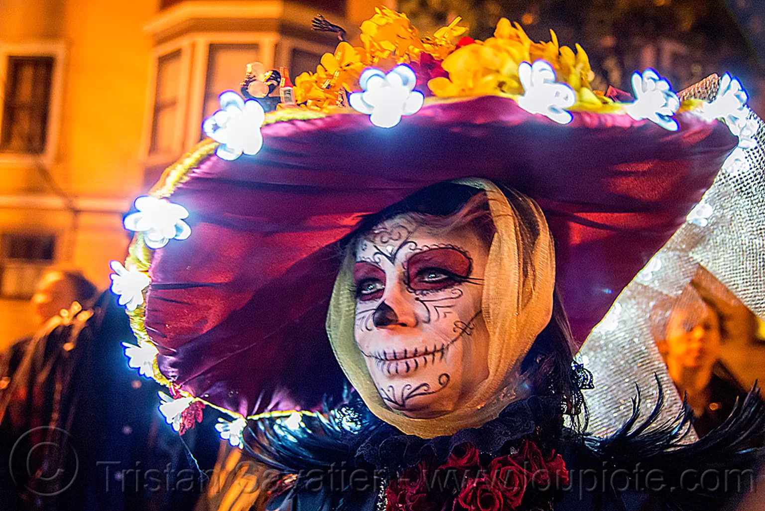 woman with wide brim purple hat, sugar skull makeup, LEDlights flowers, dia de los muertos, day