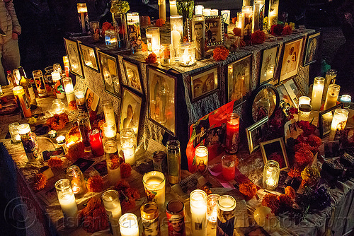 altar de muertos - glass candles - dia de los muertos, altar de muertos, candle light, day of the dead, dia de los muertos, framed images, frames, glass candles, halloween, marigold flowers, mementos, night