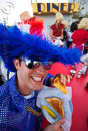 american customer eating grill-cheese sandwitch at the dust-city diner - burning man decompression, blue, customer, dust-city diner, eating, fluffy, grilled-cheese, hat, man, red, sandwitch, sunglasses, white