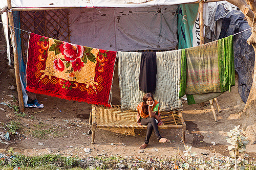 bedding on cloth line (india), bedding, blankets, comforters, girl, hanging, house, peoplecloth line, sitting, village