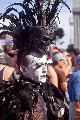 black skull headdress, bindis, black feathers, black skull, costume, eyelashes extensions, feather headdress, man, spiky, white facepaint, white makeup