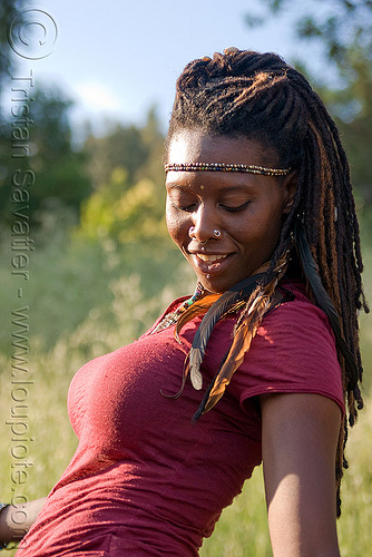 black woman dancing, black woman, dancing, feathers, headband, lala love, nose piercing, nostril piercing, spring training, thin dreadlocks