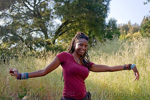 black woman dancing in park, black woman, bracelets, dancing, headband, lala love, spring training, thin dreadlocks