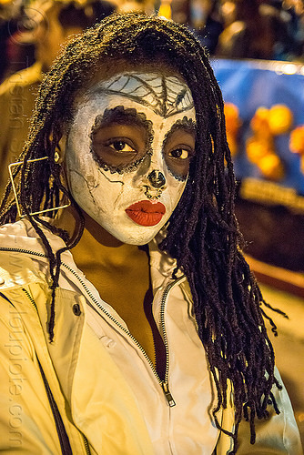 black woman with white sugar skull makeup - dia de los muertos, day of the dead, dia de los muertos, dreadlocks, face painting, facepaint, halloween, night, nose piercing, red lipstick, septum piercing, square earrings, sugar skull makeup, woman