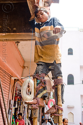 boy begging on stilts - jaipur (india), bare feet, barefoot, beggar, begging, boy, child, india, jaipur, pan handling, ropes, stilts, stiltwalker, stiltwalking, street kid
