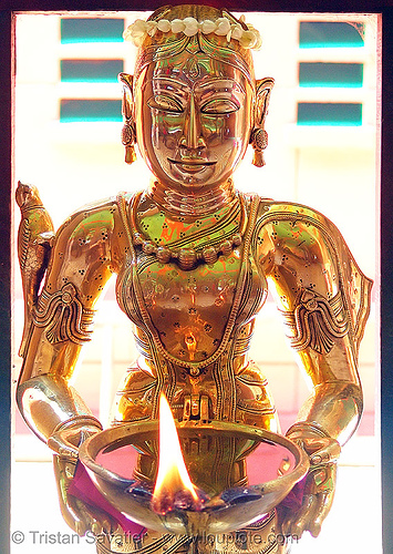brass statue of a kho me goddess - deity (saigon) - vietnam, brass, burning, fire, goddess, golden color, khmer krom, kho-me, sculpture, statue, temple, woman