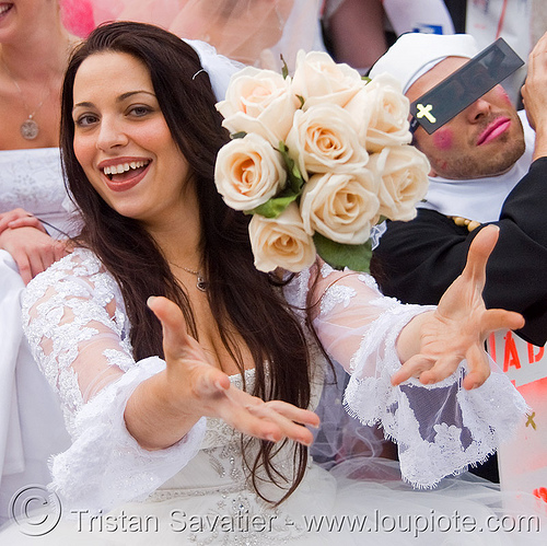 bride tossing bridal bouquet, bridal bouquet, bride, brides of march, flowers, wedding dress, white roses, woman