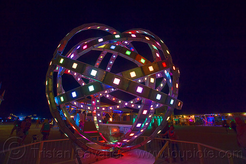 burning man - animated steel rings sculpture with led lights, animated, art installation, burning man at night, disc-go-sphere, glowing, led light, sculpture, the man
