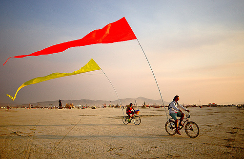 burning man - bicycles flags, bicycle flags, bicycles, poles, red, riding, streamer flags, streamers, yellow