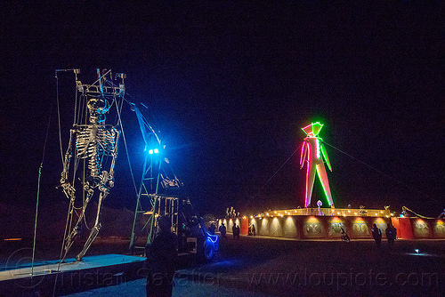 burning man - colossal skeleton marionette, burning man at night, colossal skeleton marionette, giant puppet, glowing, neon, the man