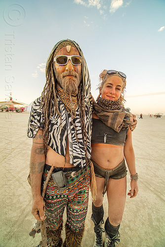 burning man - couple - burners, arm tattoos, attire, beard, burning man outfit, sunglasses, woman