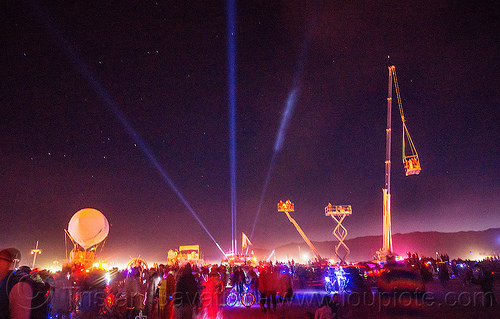 burning man - cranes and cherry pickers, burning man at night, cherry picker, crane, crowd, glowing, lasers, scissor lift