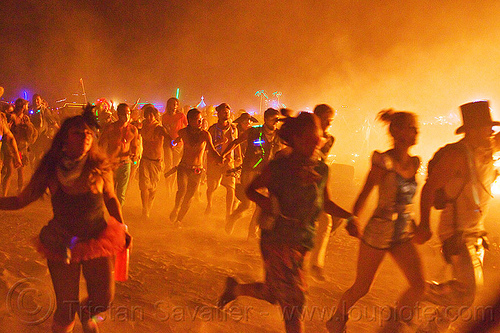 burning man - crowd running around the man's fire, burning man at night, celebrating, crowd, dust, glowing, melee, mêlée, night of the burn, running, smoke