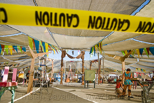 burning man - disassembling center camp cafe, caution tape, safety tape, warning tape, yellow tape