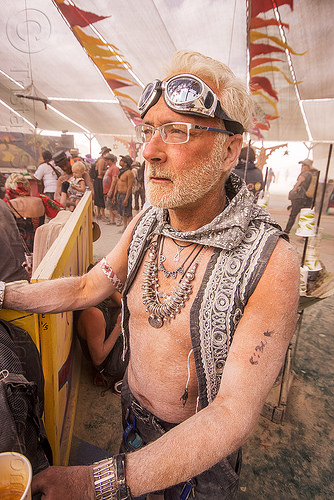 burning man - dusty man gazing at center camp, dusty, goggles, man, metal necklace, prescription glasses, spectacles, white hair