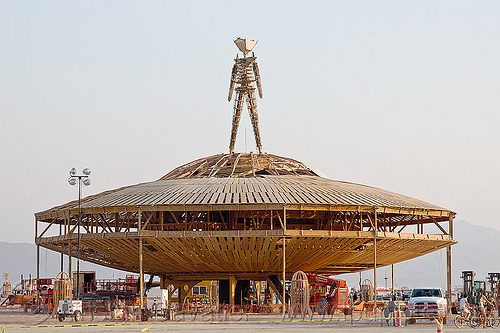 burning man - effigy stands on a large flying saucer, flying saucer, the man, ufo