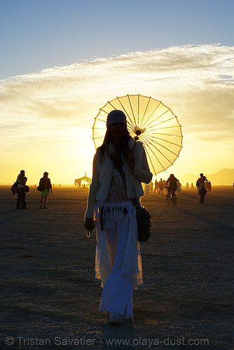 burning man - elke at the silent white procession, at dawn, back light, dawn, elke, parasol, white morning