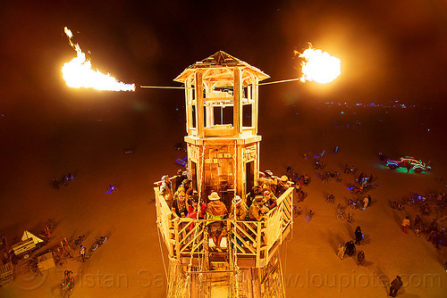 burning man - fire cannons on the lighthouse, art installation, black rock lighthouse, burning man at night, fire, light house