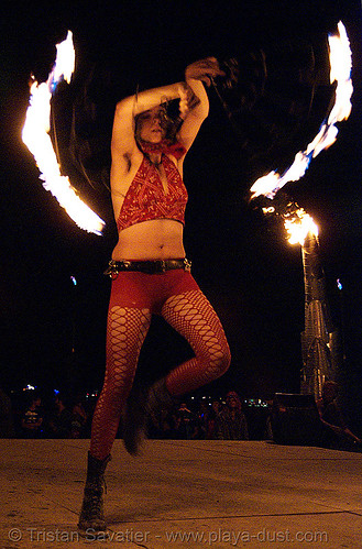 burning man - fire performer on the shiva vista stage, burning man at night, fire fans, shiva vista stage