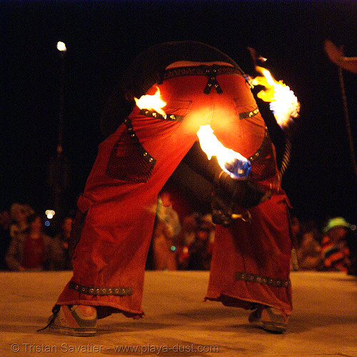 burning man - fire performer on the shiva vista stage, burning man at night, fire poi, shiva vista stage