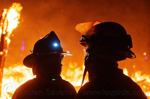 burning man - firefighters near the fire - the man is burning -, backlight, burning man at night, fire proximity suit, firefighters, head light, headlamp, helmets, night of the burn, silhouettes, the man, visor
