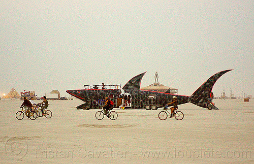 burning man - giant shark art car and bicycles, bicycles, bikes, burning man art cars, dusk, fish art car, mutant vehicles, shark art car