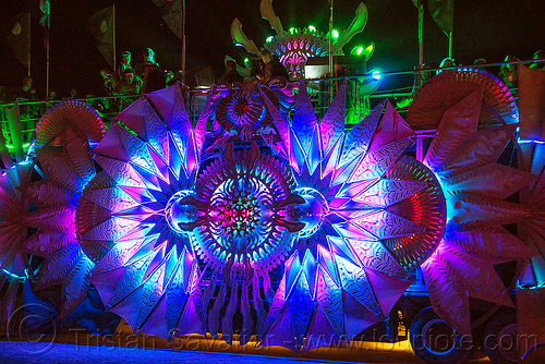 burning man - glowing color-morphing led light decoration on music art car, burning man at night, glowing, rolling root art car