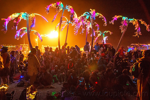 burning man - glowing palm trees art car, art car, burning man art cars, burning man at night, crowd, glowing, mutant vehicles, palm trees