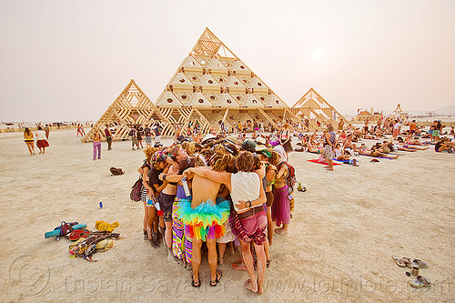 burning man - group hugging at handfasting ceremony near pyramid, burning man temple, handfasting, temple of whollyness, wedding, wooden pyramid