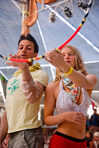 burning man - hula hoopers practicing at the center camp cafe - paul blair "dizzy hips" - ashley, arm injury, ashley, dizzy hips, hoop passing, hula hoop, hula hooper, hula hooping, man, passing hoop, paul blair, woman