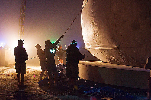 burning man - installing the giant inflatable moon, burning man at night, inflatable moon, lune and tide, silhouettes