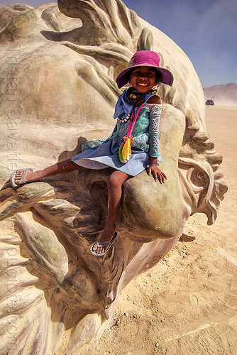 burning man - little girl on da vinci's nose, art installation, child, da vinci head, giant head, kid, little girl, purple hat, sculpture