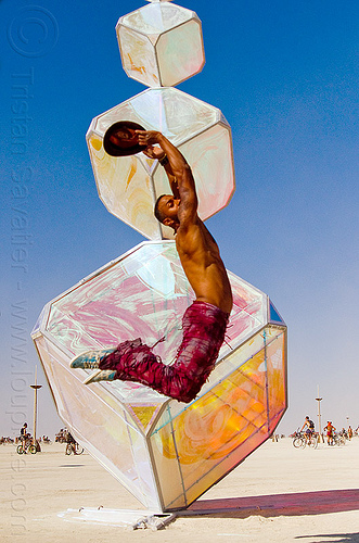 burning man - man jumping at iridescent cubes, art installation, invisible, iridescent cubes, jumpshop, kirsten berg, man, sculpture
