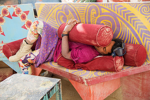 burning man - man sleeping at center camp cafe, bench, man, pillows, sleeping