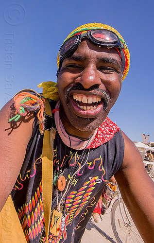 burning man - man with big smile, attire, burning man outfit, goggles, mustache