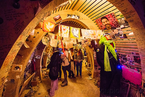 burning man - memento in the temple at night, arches, architecture, burning man at night, burning man temple, flags, mementos, temple of promise, vaults