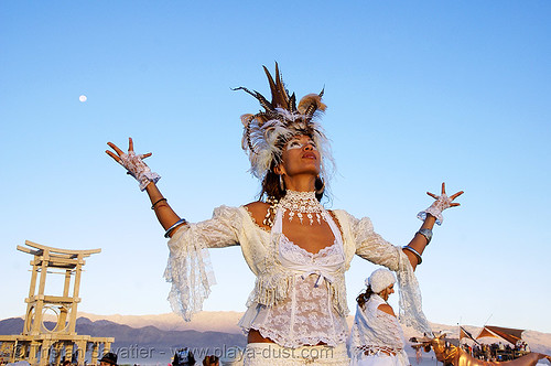 burning man - natalia at the silent white procession, attire, burning man outfit, dawn, feathers, natalia, stilts, stiltwalker, stiltwalking, white morning, woman