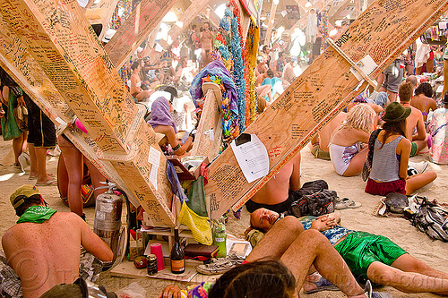 burning man - people and mementos in the temple, burning man temple, contemplatiing, graffiti, inside, interior, mementos, temple of whollyness, writing