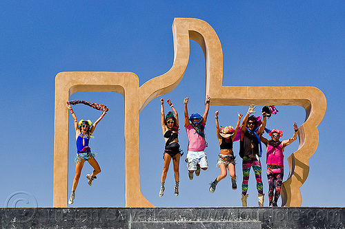 burning man - people jumping in the giant facebook "like" hand, art installation, dadara, facebook hand, facebook like, golden like, icon, jumpshop, like4real, man, sculpture, thumb up, woman