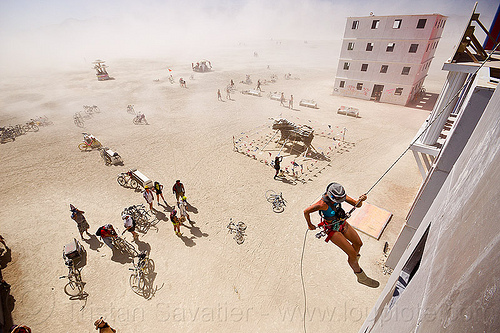 burning man - rappelling down wall street building, abseiling, buildings, climbing harness, dust storm, haboob, hat, rappelling, rock climbing, single rope, static rope, vertical, wall street, white out, woman